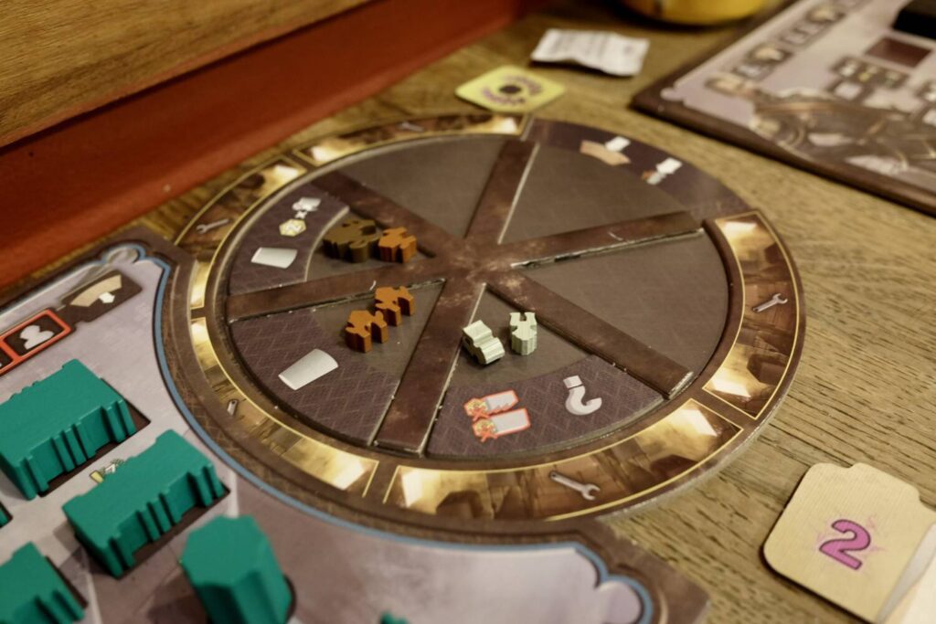 The construction wheel is a circle divided into six pie slices. Each slide has room for an action tile and resources.