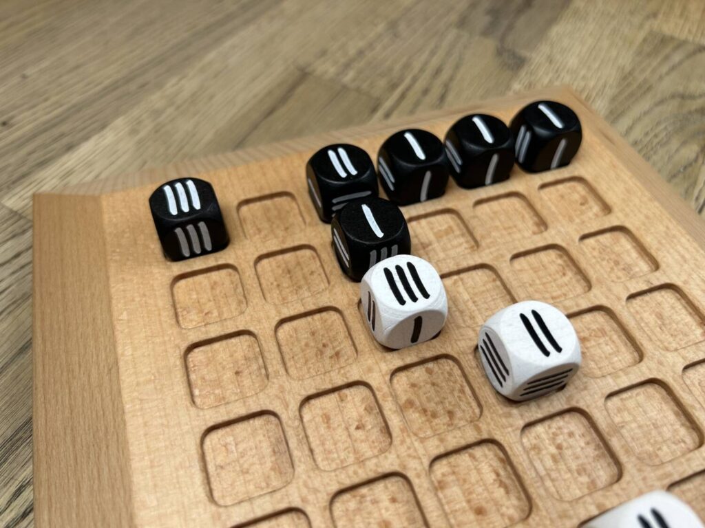 One player has managed to line up a black 2, black 1, and white 3, in that order, making a Triad.