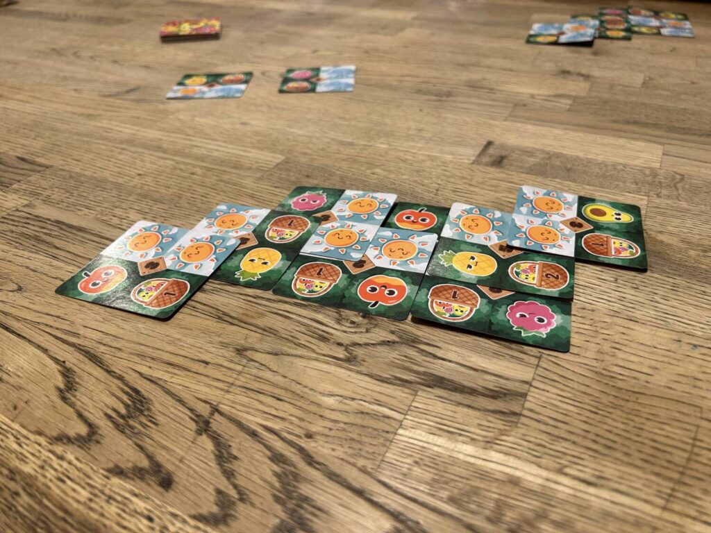 Pocket Farm cards laid atop one another in an elaborate lattice.