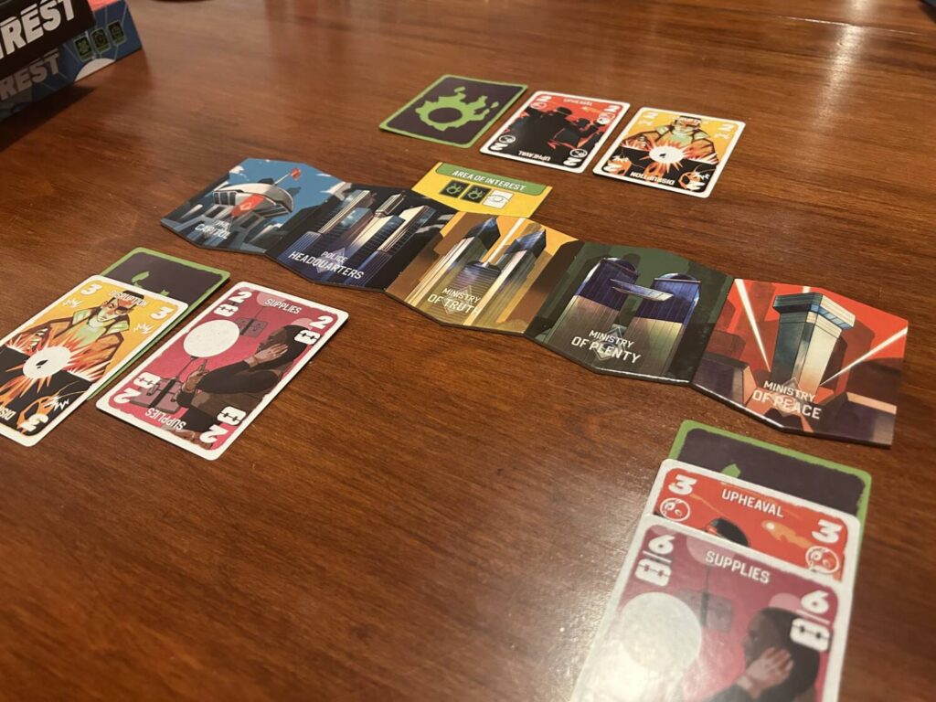 The five regions of Unrest laid out in a row, with cards beneath.