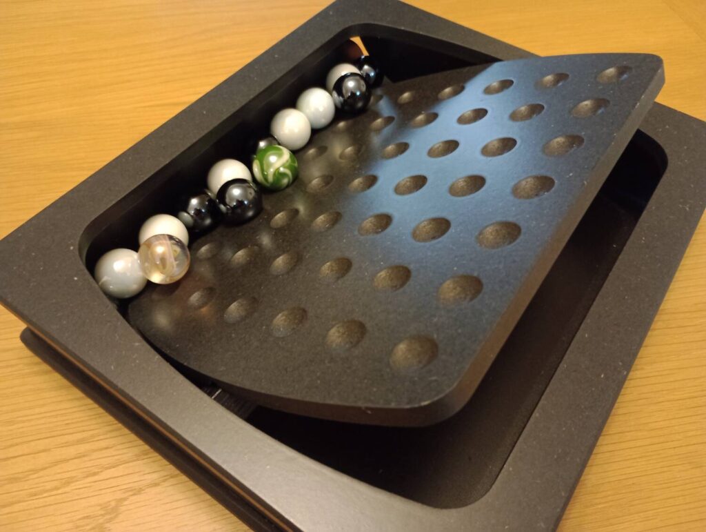 The board has tipped, all the marbles crashing into the body of the board itself.