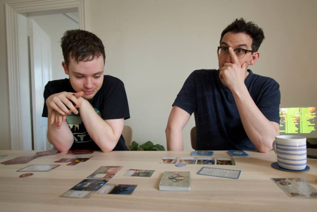 Two of my friends at the table during the game.