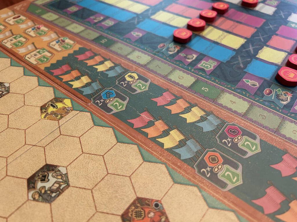 The bonuses are listed down the middle of the board, each marked with flag tokens as they are accomplished.