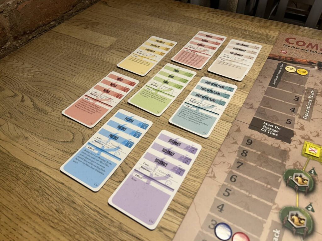 The Culture deck laid out to the left of the board, eight sets of three cards in different colors.