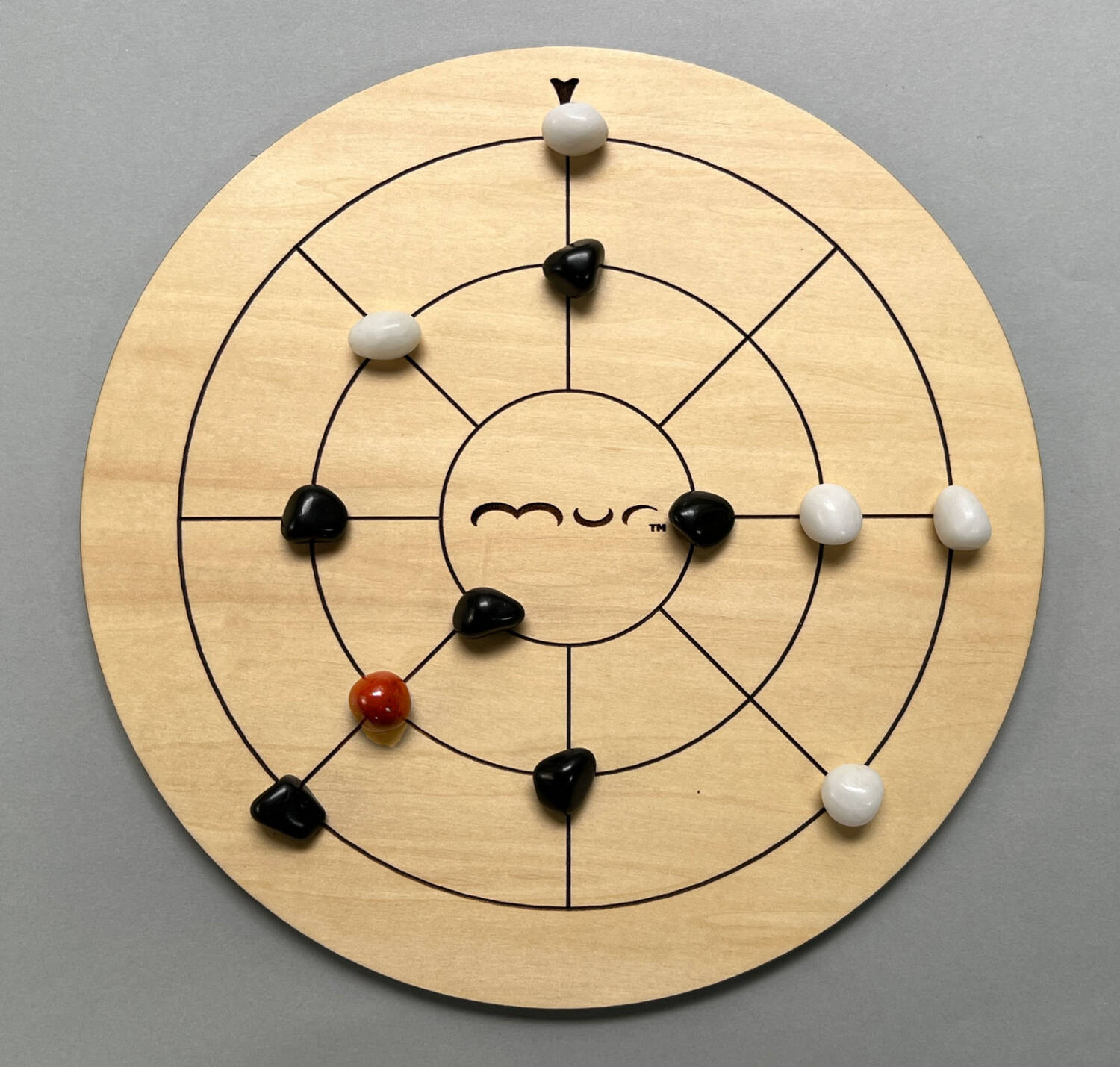...where is it surrounded on all four sides by black stones. Black wins this game.