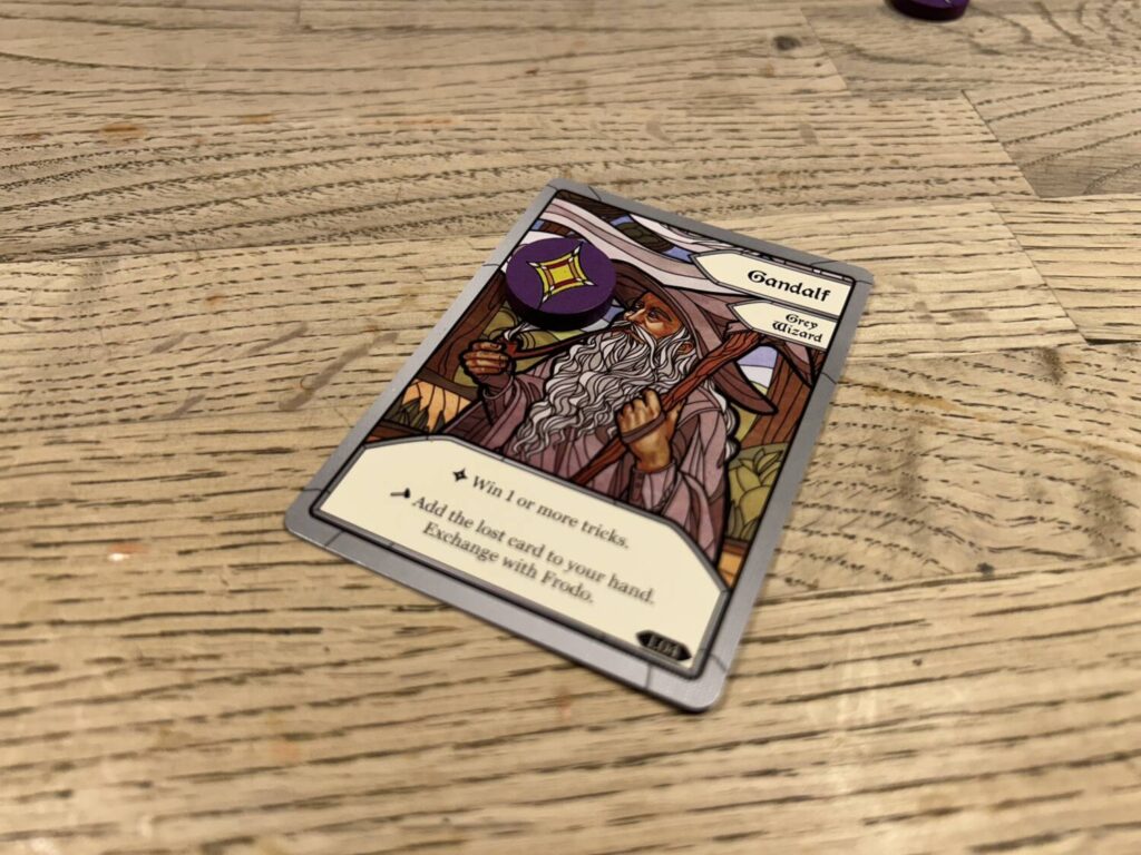 The Gandalf card, for example, features an image of Gandalf above a text window stating his goal, "Win 1 or more tricks," and any setup procedures he needs to follow.