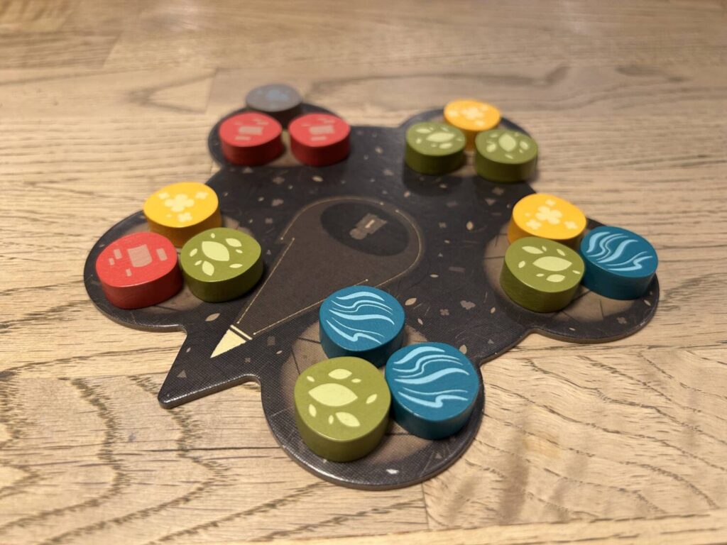 The board from which players take sets of tiles is a strange shape, a sort of five-pointed star with fat points. On each point sit three tokens.