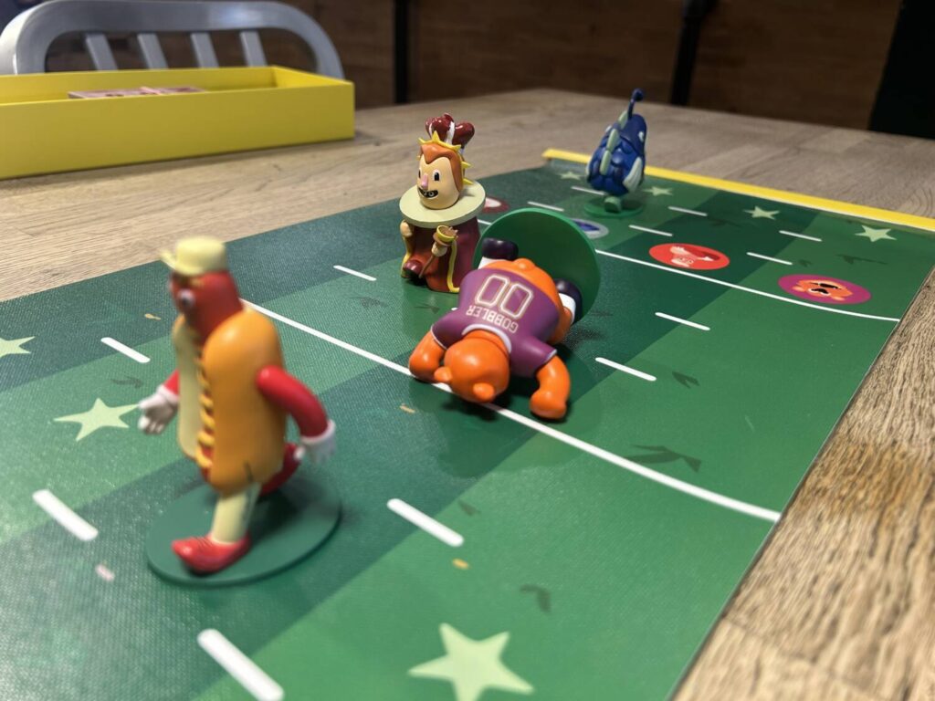 The hot dog leads, the bear is laying on the ground, and the fish, way to the back, is running the other way.