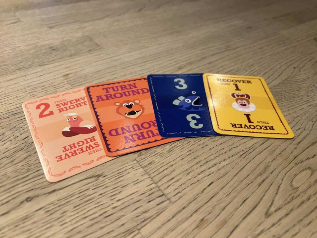 The cards for each character are colored to match. Here, one card for each character is laid out in a row.