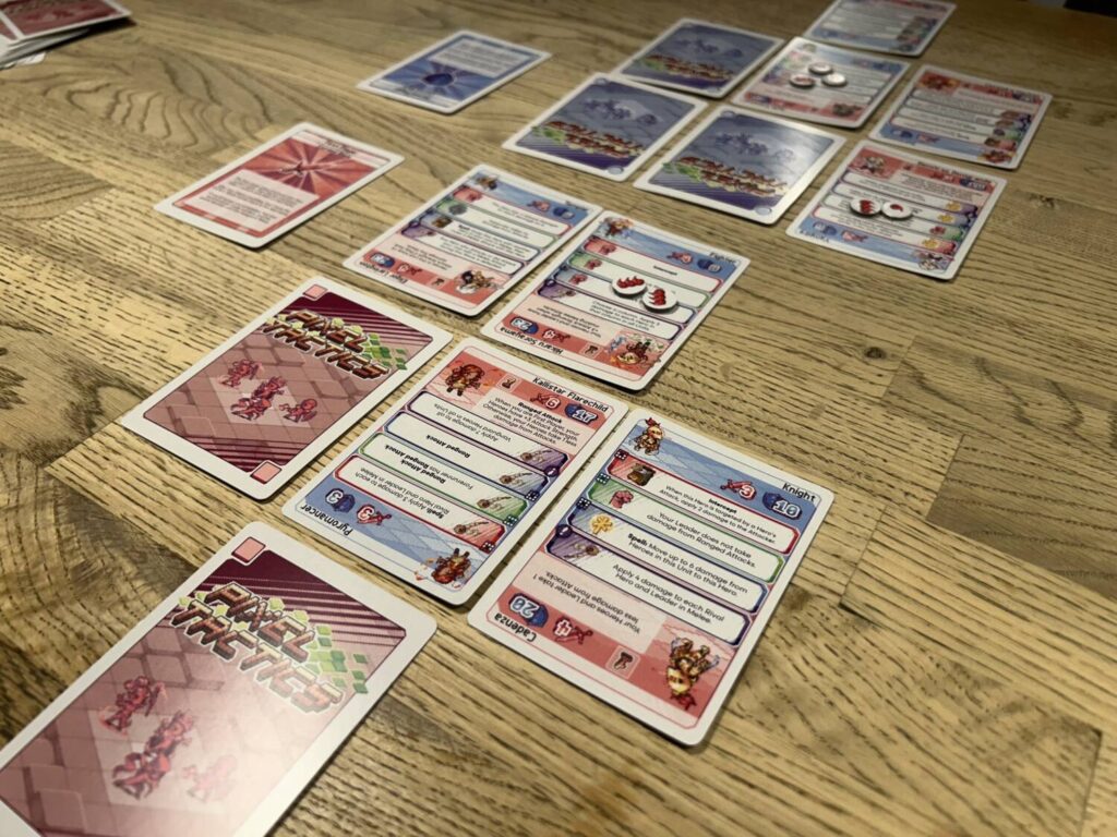 Two formations face one another. Some slots are empty. Others are occupied by Hero or Leader units. A few are occupied by facedown cards, which represented the corpses of slain Heroes.