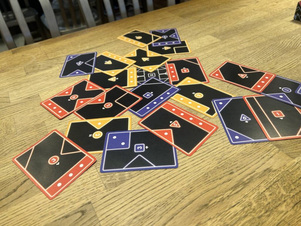 More overlapping cards on a wooden table.