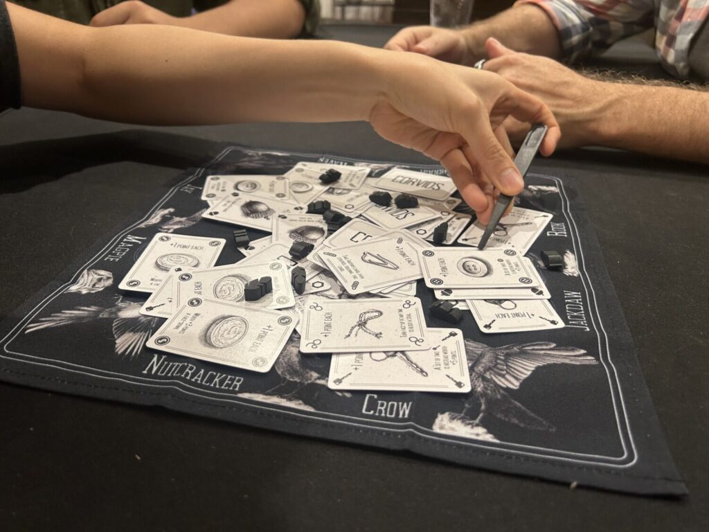 Another photo of a hand with long tweezers flipping a card.