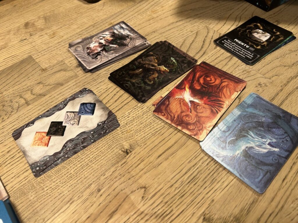 Four decks of cards, in white, black, orange, and blue.