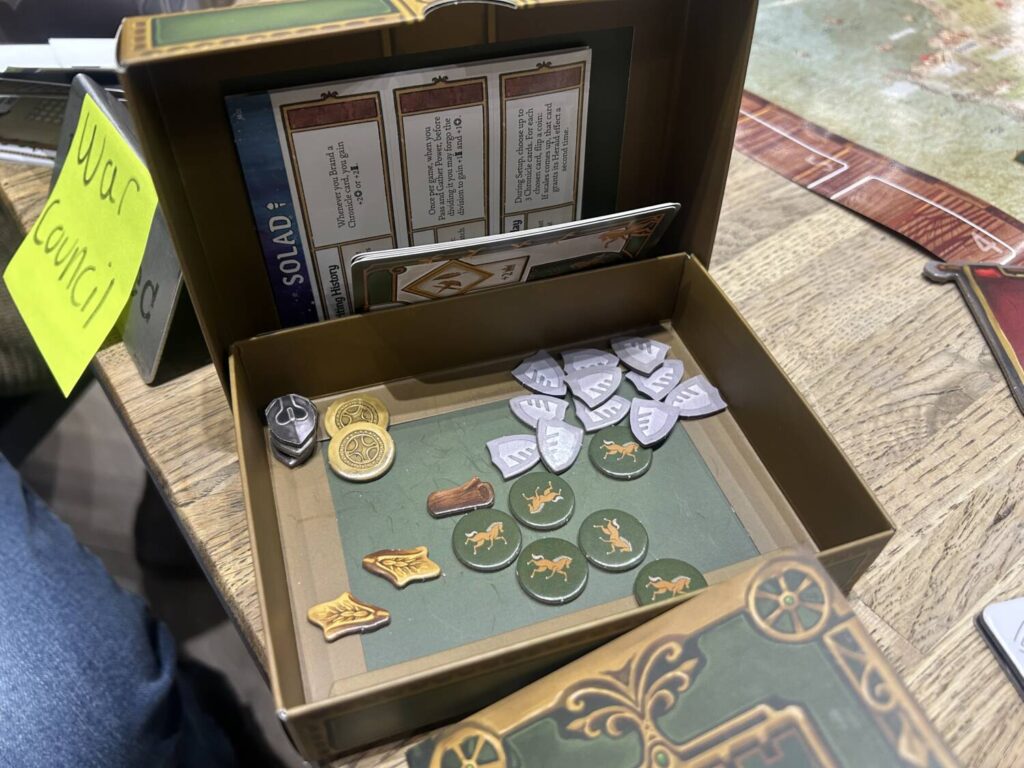 The inside of a player's treasury box, which includes resource tokens and stickers that can be unlocked in the future.
