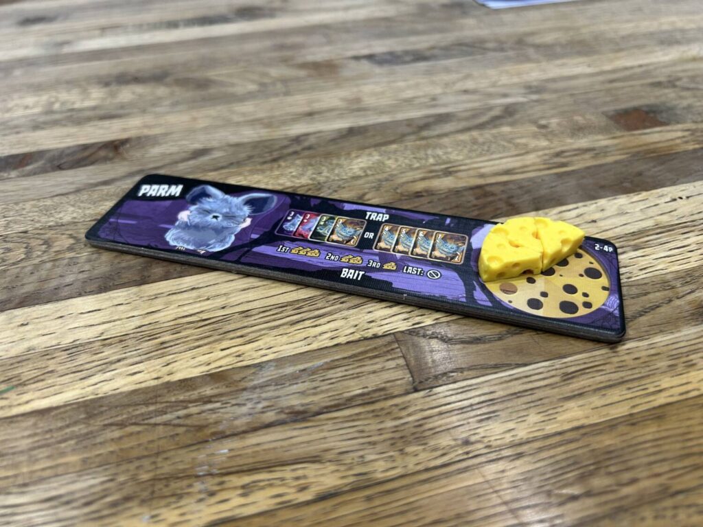 Plastic cheese wedges in a semi-circle on a player board.