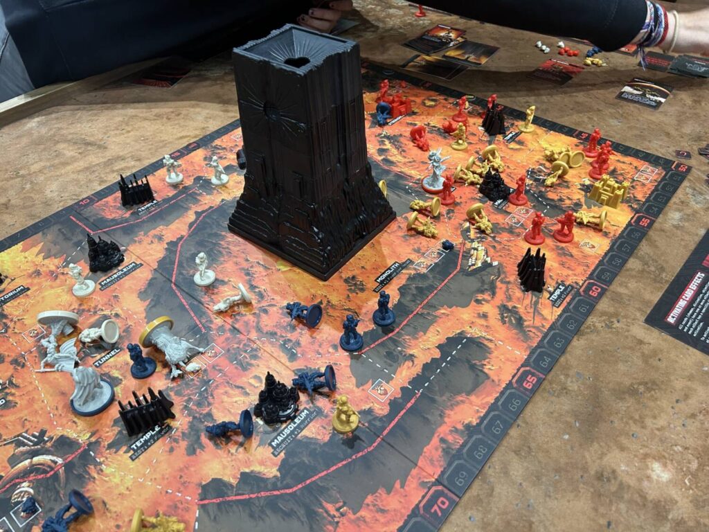 A board covered in minnies, with a giant black tower in the middle.